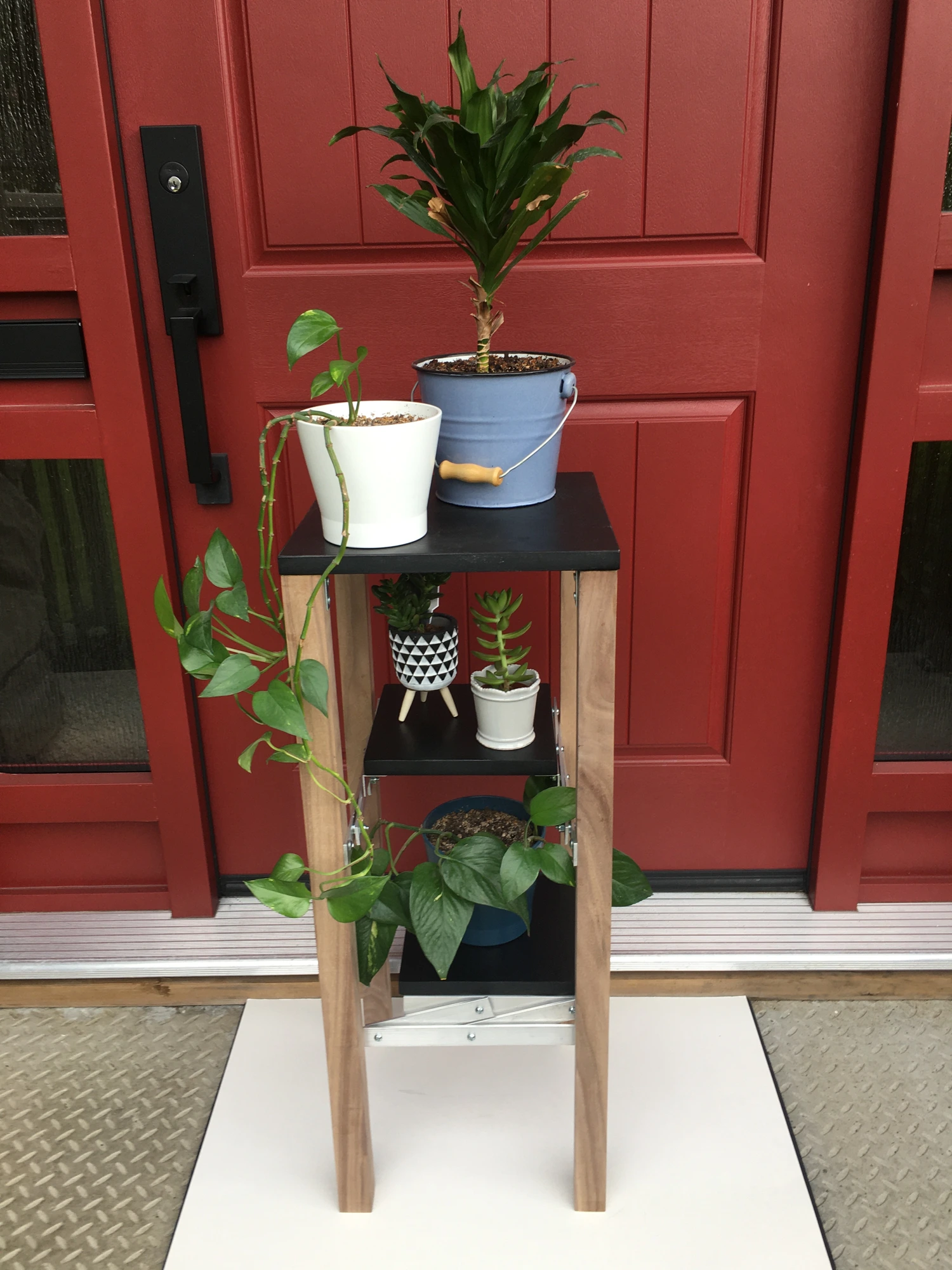 Plant stand with the shelves tucked into the frame.