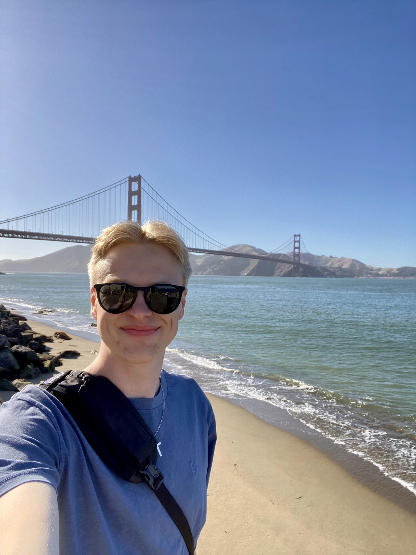 Cameron by the water with the Golden Gate Bridge in the background